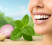 Smiling woman with mint, onion, and garlic beside Mountain Breeze branding, promoting instant mouth freshener benefits