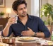 Man experiencing bad breath and acid reflux symptoms after a meal