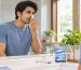 Young Indian adult checking for bad breath before leaving home