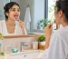 Young Indian adult using a tongue scraper for bad breath as part of an oral hygiene routine